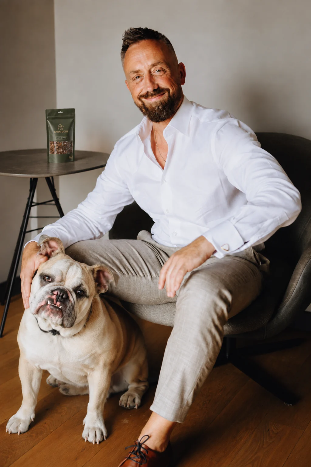 Robert von Jutschenka, Gründer von BabaFuchs, mit einem Hund und einer BabaFuchs-Produktvisualisierung auf dem Beistelltisch